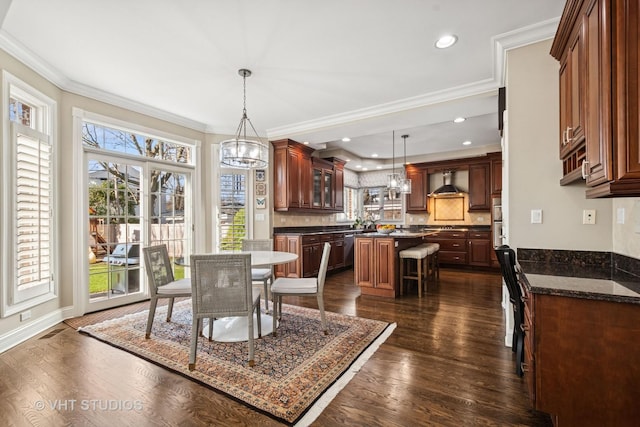 dining space featuring baseboards, an inviting chandelier, ornamental molding, dark wood finished floors, and recessed lighting