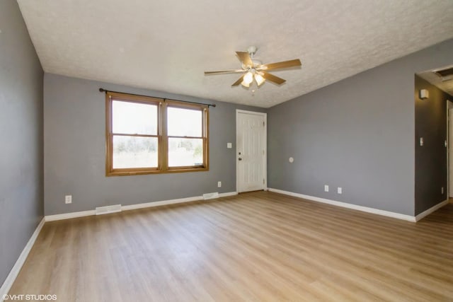 1105 Eileen St, Coal City, IL 60416 - spare room featuring wood finished floors, ceiling fan, baseboards, and a textured ceiling
