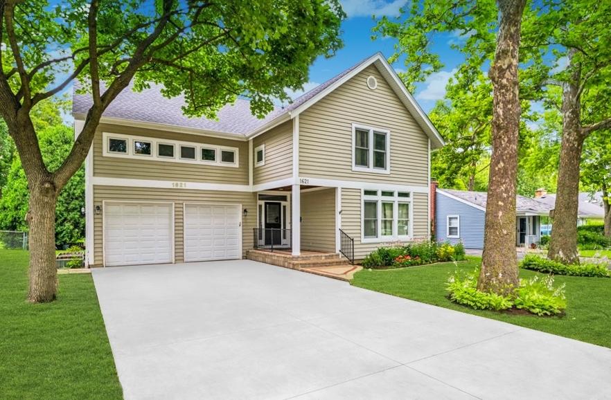 1621 Grove Ave, Highland Park, IL 60035 - traditional-style home featuring an attached garage, a front yard, and driveway