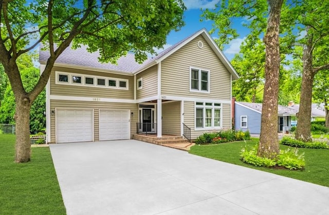 1621 Grove Ave, Highland Park, IL 60035 - traditional-style home featuring an attached garage, a front yard, and driveway