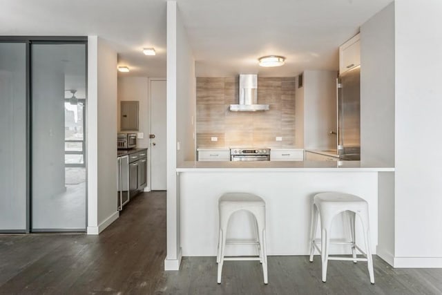1636 N Wells St Unit 609, Chicago, IL 60614 - kitchen featuring wall chimney range hood, stove, electric panel, and dark wood-style flooring