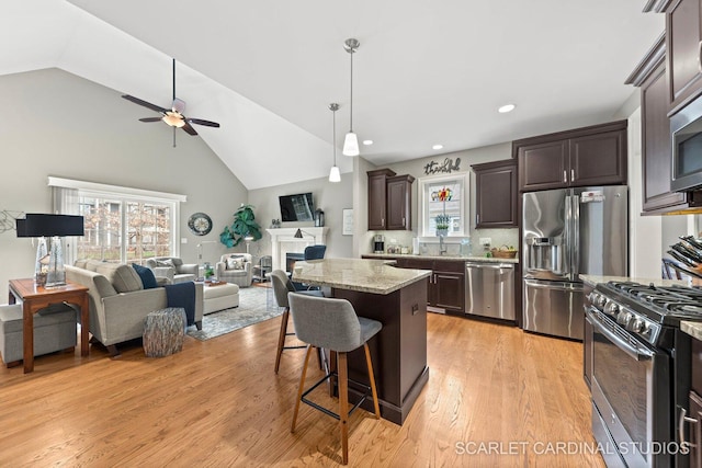 2793 Nicole Cir, Aurora, IL 60502 - kitchen featuring dark brown cabinetry, open floor plan, a breakfast bar area, ceiling fan, and appliances with stainless steel finishes