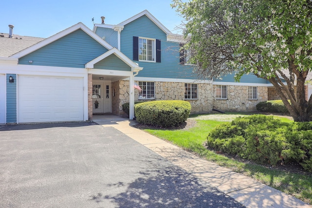 301 Memory Ln Unit 3C, Westmont, IL 60559 - view of front of house with stone siding, a garage, and asphalt driveway