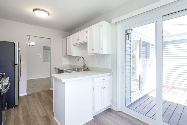 301 Memory Ln Unit 3C, Westmont, IL 60559 - kitchen with a sink, wood finished floors, white cabinetry, and light countertops