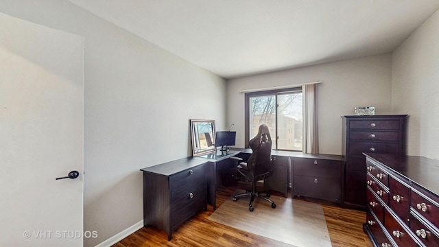 office space featuring baseboards and wood finished floors