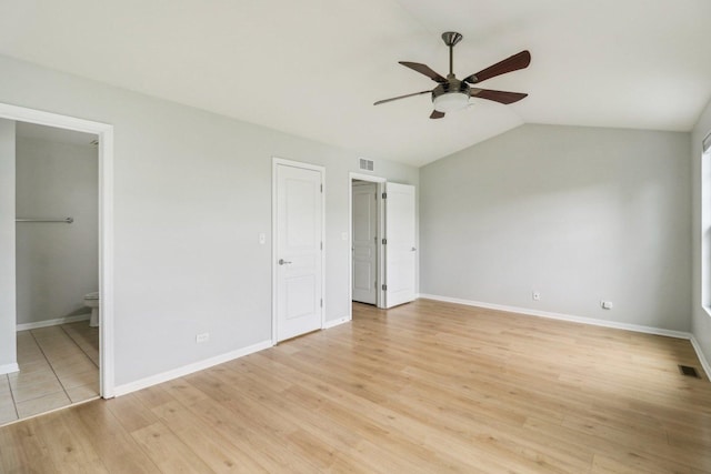 2303 Neubauer Cir, Lindenhurst, IL 60046 - unfurnished bedroom with baseboards, light wood finished floors, lofted ceiling, connected bathroom, and ceiling fan