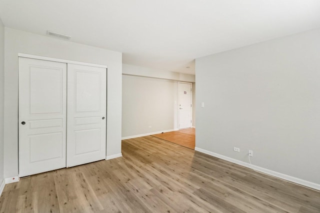 2303 Neubauer Cir, Lindenhurst, IL 60046 - unfurnished bedroom featuring light wood-type flooring, baseboards, and a closet