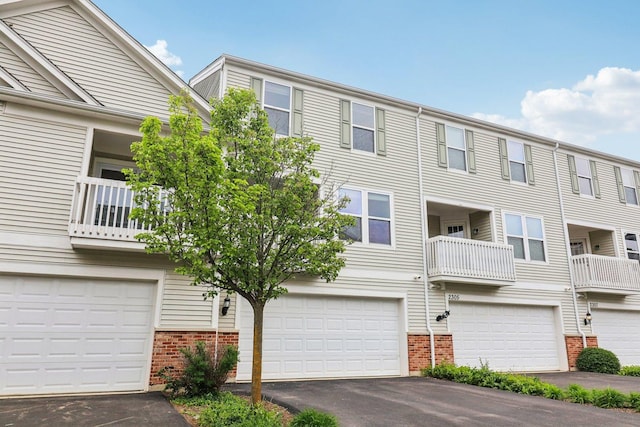 2303 Neubauer Cir, Lindenhurst, IL 60046 - view of front of home with brick siding, asphalt driveway, and a garage