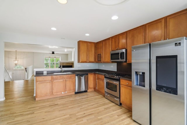 2303 Neubauer Cir, Lindenhurst, IL 60046 - kitchen featuring stainless steel appliances, a sink, dark countertops, brown cabinetry, and recessed lighting