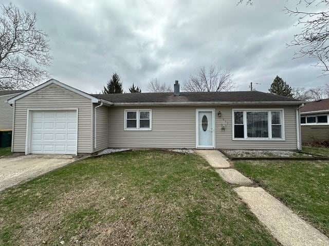 ranch-style home with a front yard, driveway, and a garage