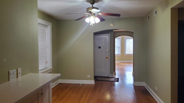 6147 N Mozart St Unit 3, Chicago, IL 60659 - foyer featuring arched walkways, a ceiling fan, and wood finished floors