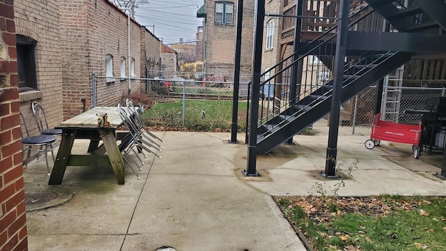 6147 N Mozart St Unit 3, Chicago, IL 60659 - view of patio featuring stairs and outdoor dining space