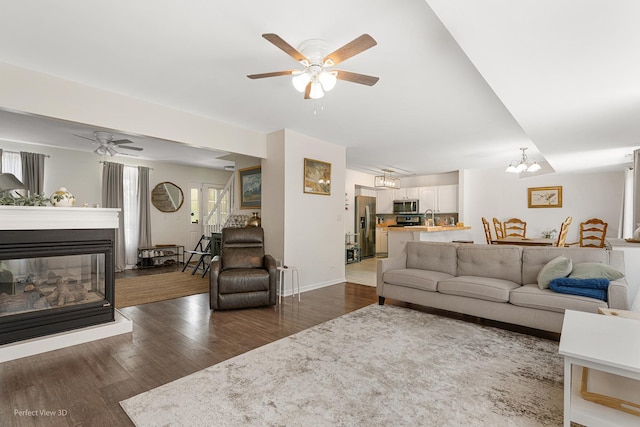 1704 Walnut Park Ln, Aurora, IL 60504 - living area with ceiling fan, dark wood-style flooring, and a multi sided fireplace