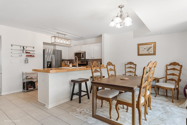 1704 Walnut Park Ln, Aurora, IL 60504 - dining room featuring a chandelier and baseboards
