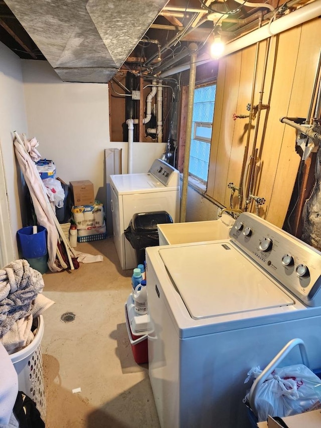 laundry room with independent washer and dryer, laundry area, and a sink