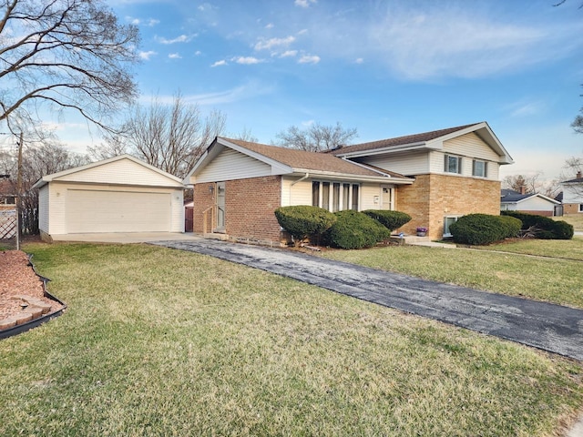tri-level home with brick siding, an outbuilding, a front lawn, and a detached garage