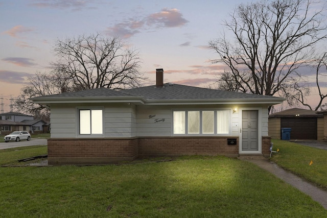 920 163rd St, Calumet City, IL 60409 - bungalow featuring a front yard, brick siding, a chimney, and an outbuilding
