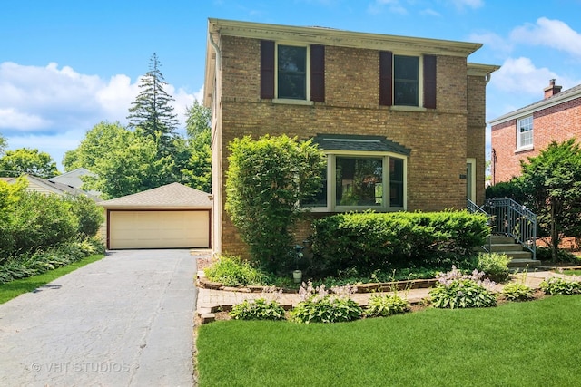 212 N Russel St, Mount Prospect, IL 60056 - view of front of home featuring a detached garage, brick siding, a front lawn, and an outbuilding