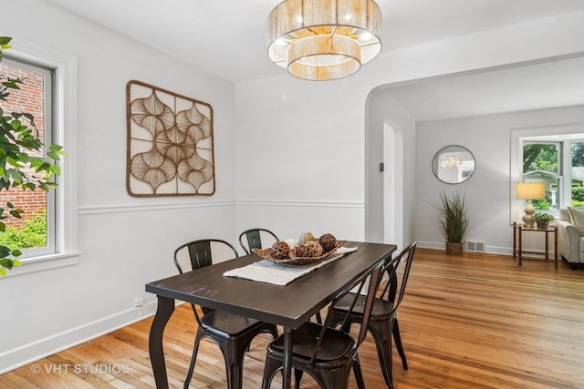 212 N Russel St, Mount Prospect, IL 60056 - dining area featuring arched walkways and light wood finished floors