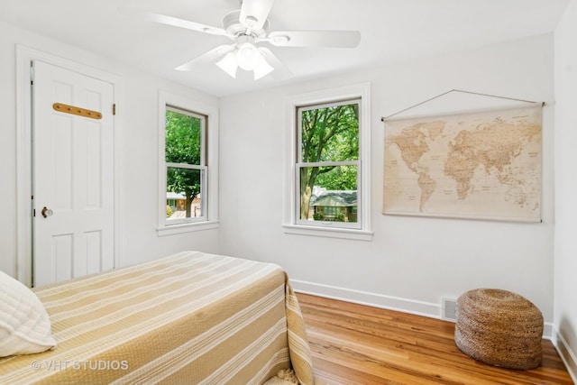 212 N Russel St, Mount Prospect, IL 60056 - bedroom featuring multiple windows, wood finished floors, and ceiling fan