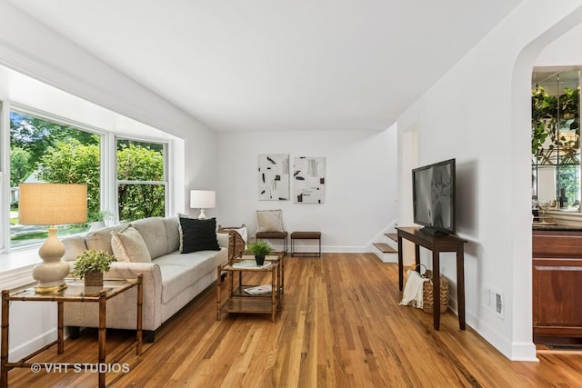 212 N Russel St, Mount Prospect, IL 60056 - living area featuring arched walkways, light wood-type flooring, and stairway