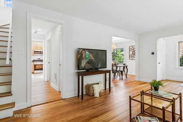 212 N Russel St, Mount Prospect, IL 60056 - living area featuring stairs, healthy amount of natural light, light wood-style floors, and arched walkways