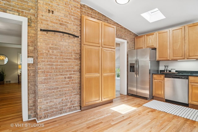 212 N Russel St, Mount Prospect, IL 60056 - kitchen featuring appliances with stainless steel finishes, a skylight, vaulted ceiling, light wood-type flooring, and dark countertops