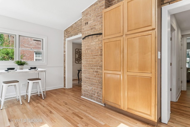 212 N Russel St, Mount Prospect, IL 60056 - kitchen featuring light brown cabinets, lofted ceiling, light wood-style floors, and brick wall
