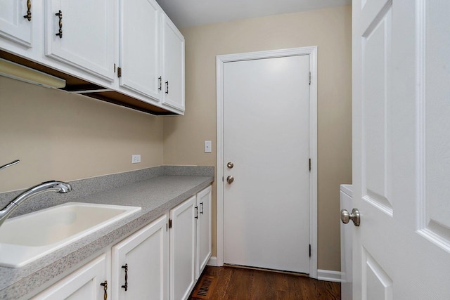 laundry room with dark wood-style floors and a sink
