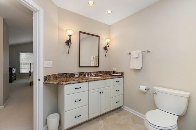 bathroom with vaulted ceiling, toilet, vanity, baseboards, and recessed lighting