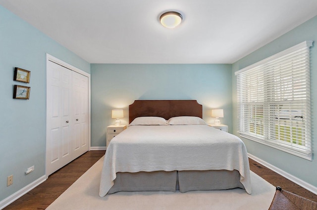 bedroom featuring a closet, baseboards, and wood finished floors