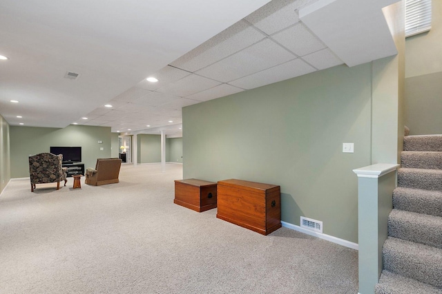 finished basement featuring recessed lighting, carpet flooring, visible vents, and stairway