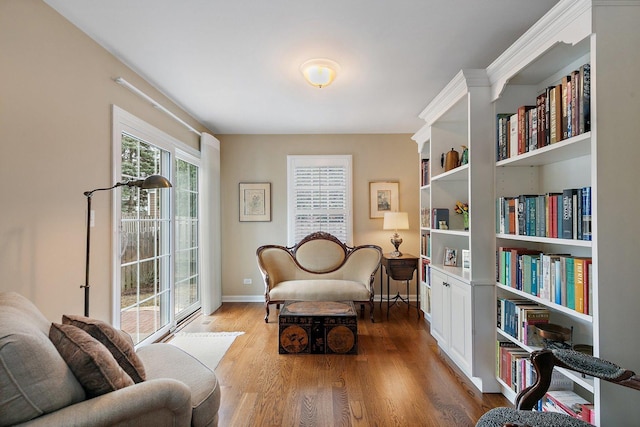 living area featuring baseboards and wood finished floors