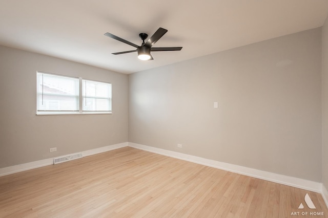 unfurnished room with baseboards, visible vents, light wood-style floors, and ceiling fan