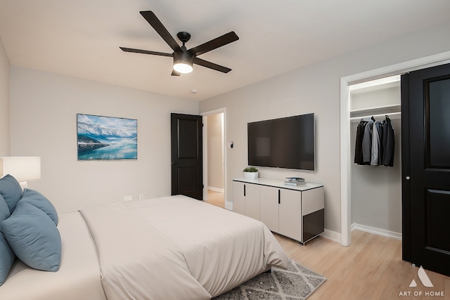 bedroom with a closet, baseboards, light wood finished floors, and ceiling fan