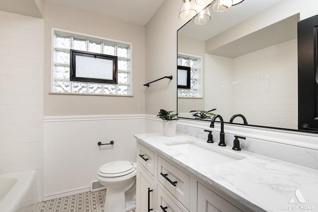 bathroom with toilet, vanity, a chandelier, wainscoting, and visible vents