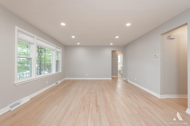 empty room featuring recessed lighting, light wood-style floors, baseboards, and visible vents