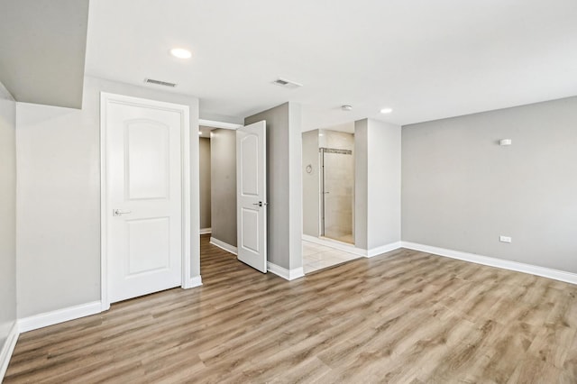 spare room with baseboards, visible vents, and light wood-style flooring