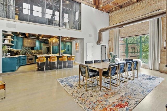 dining room featuring a high ceiling and light wood-style flooring