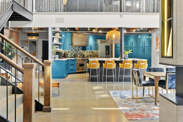 interior space featuring stairway, a high ceiling, wood finished floors, high end stainless steel range oven, and decorative backsplash