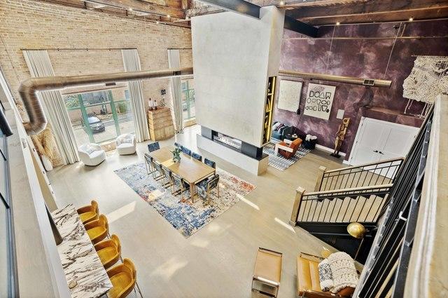 living area with a high ceiling and brick wall