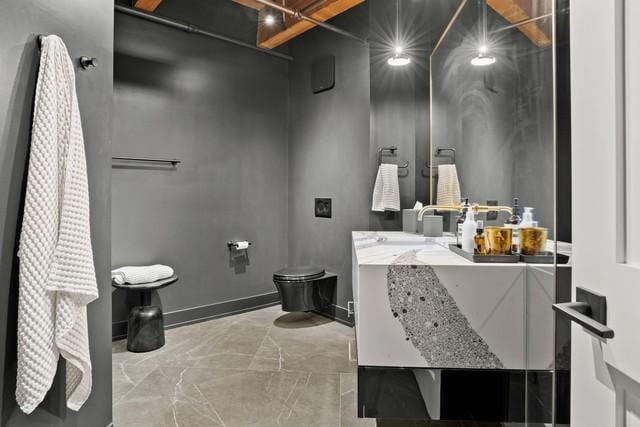 bathroom featuring marble finish floor, toilet, and vanity