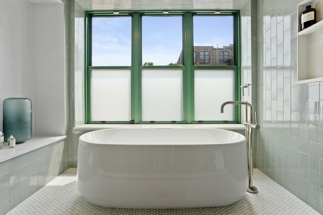 full bathroom with a freestanding tub and tile patterned floors