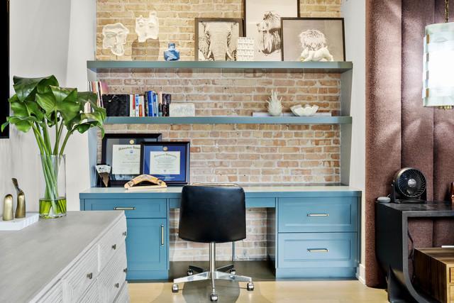 office space with brick wall and built in study area