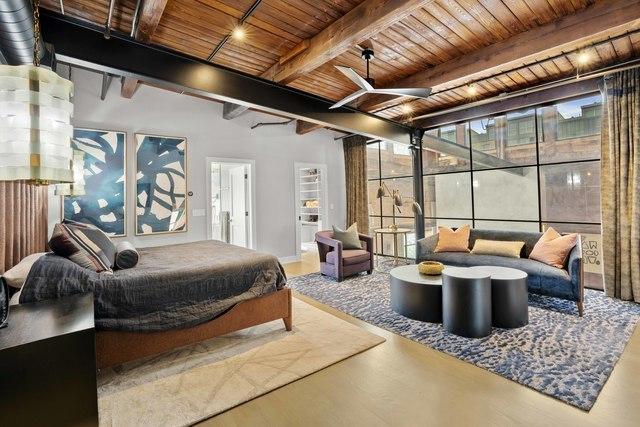 bedroom featuring beamed ceiling, wooden ceiling, and concrete floors