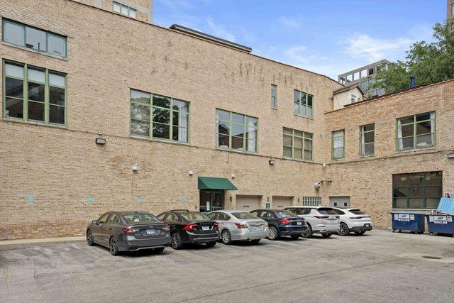 view of building exterior with uncovered parking