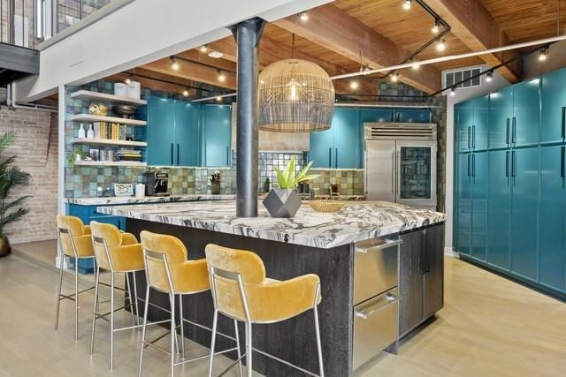 bar with beam ceiling, stainless steel built in fridge, brick wall, a warming drawer, and backsplash