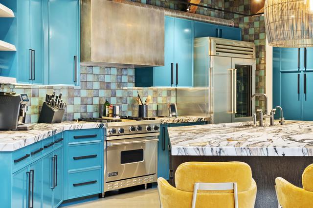 kitchen featuring blue cabinetry, tasteful backsplash, open shelves, a sink, and high end appliances