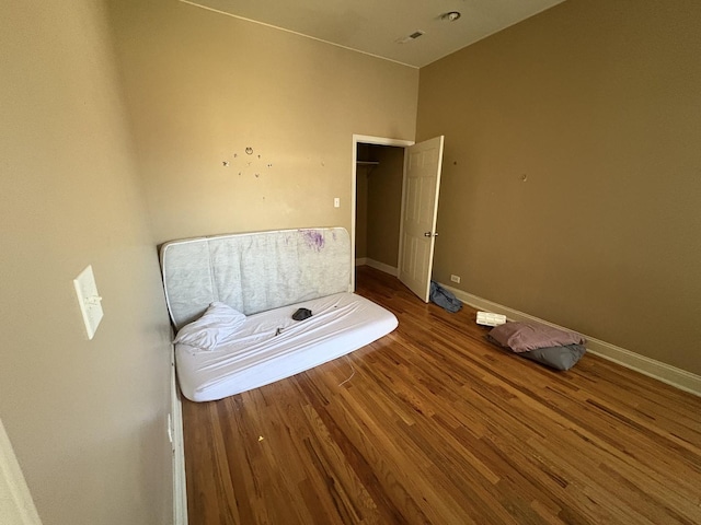 bathroom with baseboards, visible vents, and wood finished floors