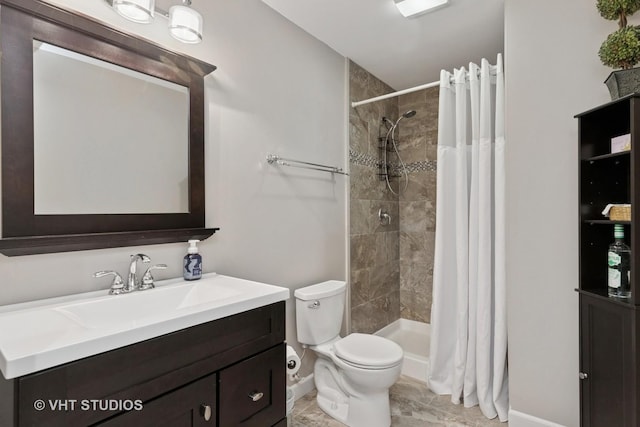 full bath featuring a shower stall, baseboards, toilet, and vanity